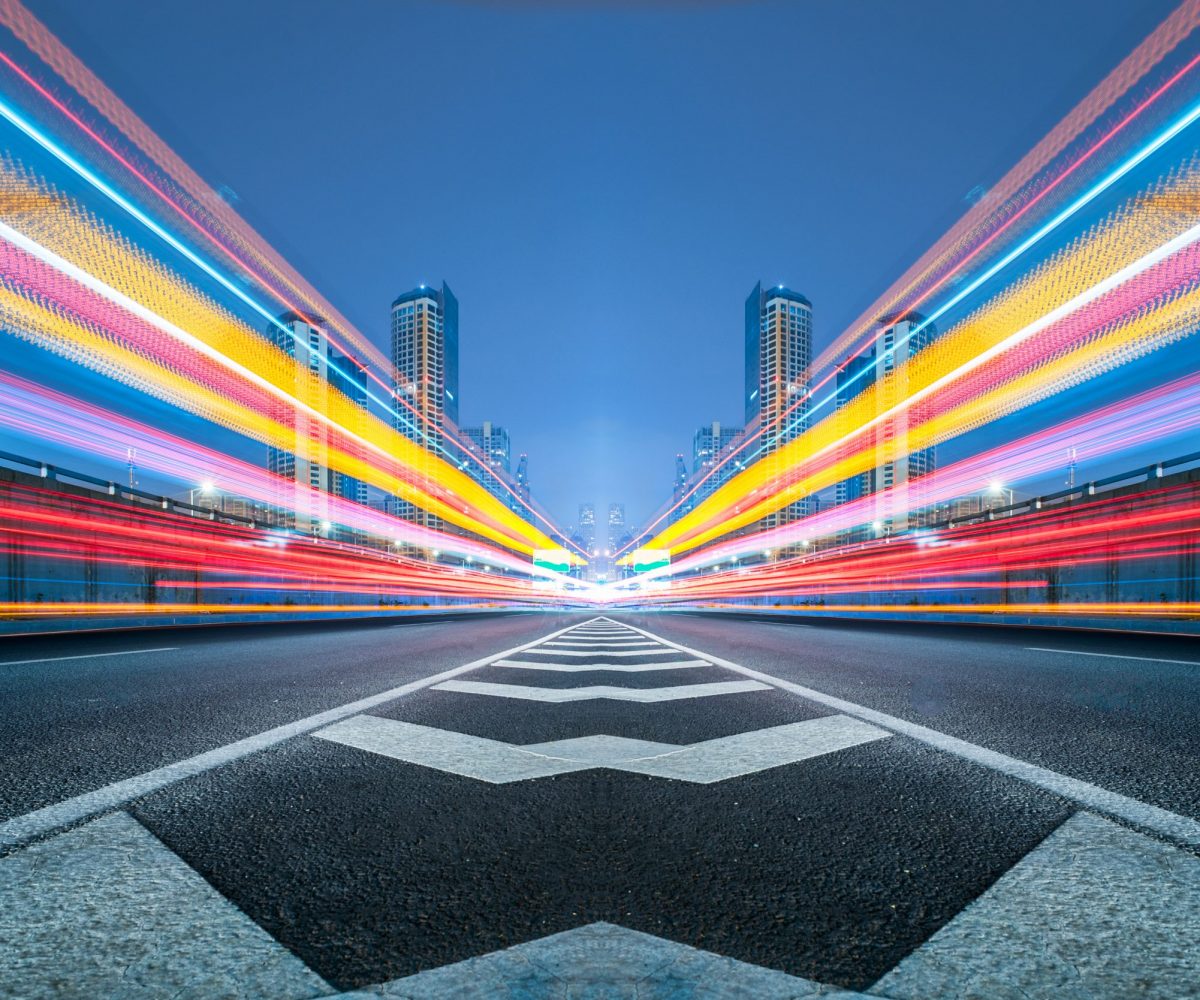 blurred traffic light trails on road at night in China.