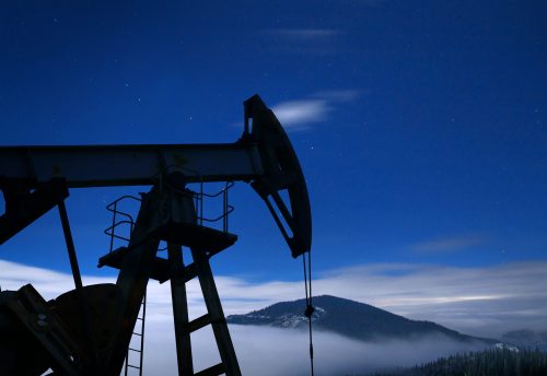 Oil pump silhouette at night.